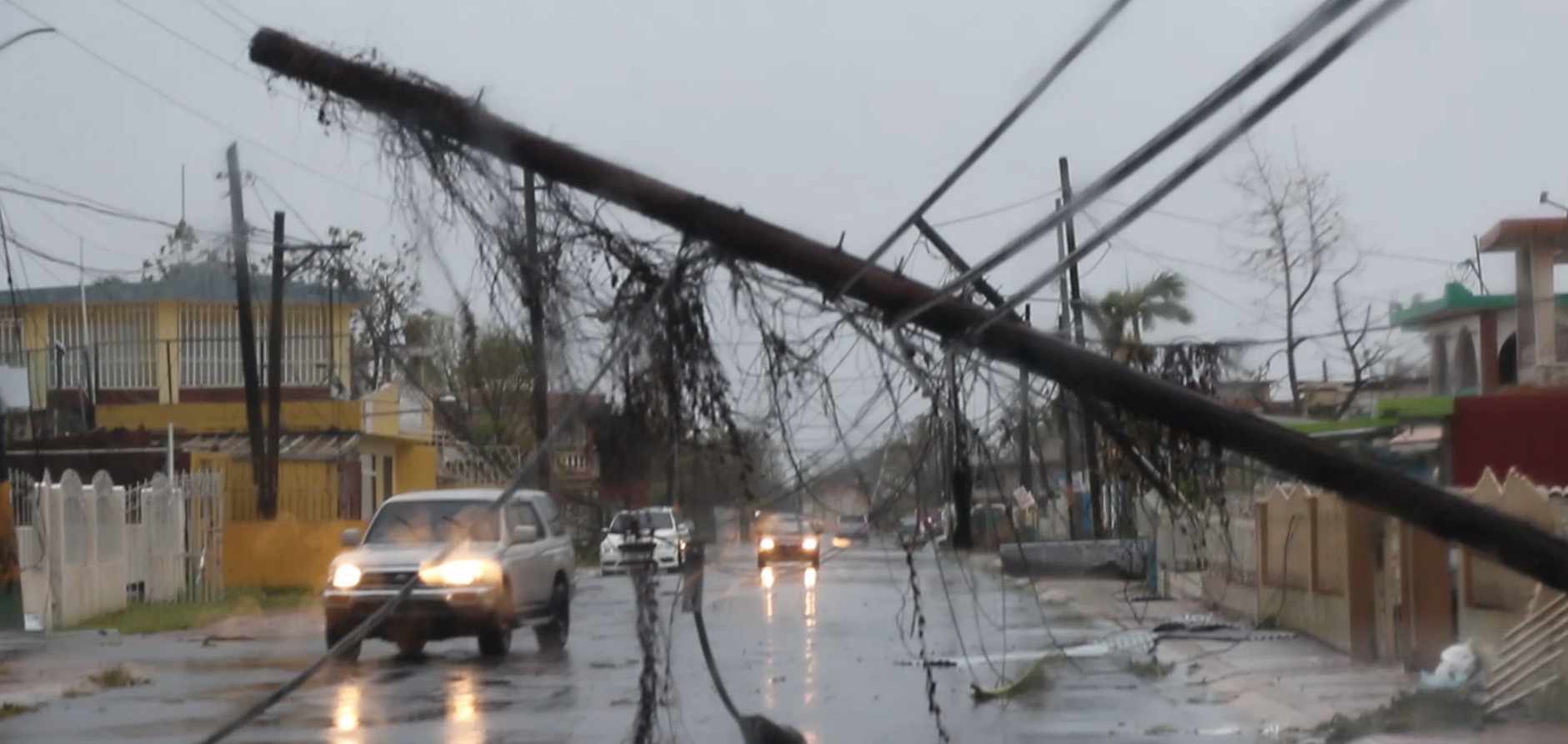 Downed power lines on a flooded Puerto Rico street after a hurricane